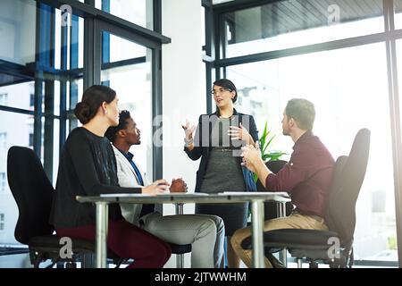 Lösung von Problemen und Suche nach neuen Lösungen. Eine Geschäftsfrau, die ihren Mitarbeitern eine Präsentation vorstellt. Stockfoto