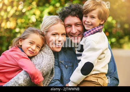 Teilen von Momenten, die am wichtigsten sind. Porträt einer glücklichen Familie, die draußen viel Zeit miteinander verbringt. Stockfoto