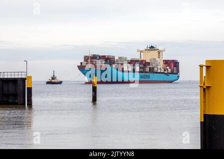 Schlepper führt das Containerschiff Maersk Luz zum Entladebereich im Überseehafen Bremerhaven Stockfoto