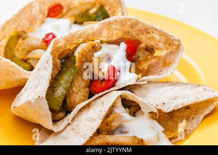 Vollkornpitta-Brot gefüllt mit gegrilltem Hühnerfleisch, Jalapenos und rotem Pfeffer Stockfoto