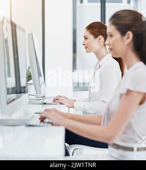 Unterstützung von Kunden online. Geschäftsfrauen arbeiten an ihrem Schreibtisch. Stockfoto