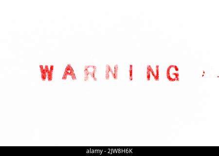 Rote Farbtinte Gummistempel in Wort Warnung auf weißem Papier Hintergrund Stockfoto
