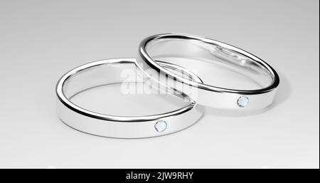 3D Rendering realistischer minimaler Diamantringe. Silberner Solitär-Verlobungsring, diamantene Ewigkeitsbänder auf weißem Hintergrund. Konzeptionelles Design für ein Stockfoto