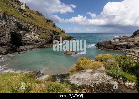 tintagel Bay cornwall unterhalb der Burg mit blauem Himmel und Wolken Stockfoto