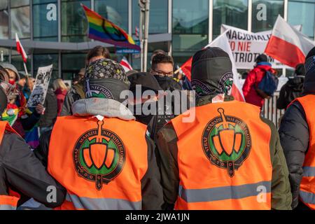 Warszawa, Polen. 11.. November 2021. Mitglieder der Nationalgarde-Organisation trennen linke Aktivisten des Unabhängigkeitsmarsches mit einer Absperrung. Am 11. November wird der unabhängigkeitsmarsch jährlich von radikalen nationalen Kreisen organisiert. Der marsch weckt in der Gesellschaft viele Ängste und Emotionen aufgrund der Verluste, die Warschau nach diesem marsch in den vergangenen Jahren erlitten hat, kamen an diesem Tag Polizeieinheiten aus allen Polen in die Hauptstadt, um Ordnung und Sicherheit der Demonstranten zu gewährleisten. (Foto von Pawe? Wróblewski/SOPA Images/Sipa USA) Quelle: SIPA USA/Alamy Live News Stockfoto