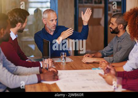 Erklärung der besten Strategie. Geschäftsleute, die ein Meeting in einem Büro abhalten. Stockfoto