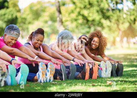 Eine Gruppe von Menschen, die sich im Freien aufwärmen. Stockfoto