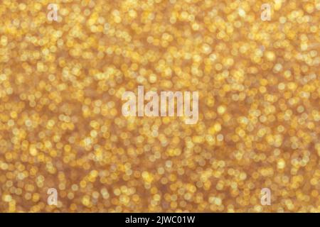 Gold hell glänzend Bokeh abstrakt verwischen Hintergrund mit hellen runden Unschärfe goldenen Muster Stockfoto