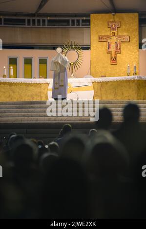 Ein Priester segnet die Gläubigen mit dem Allerheiligsten Sakrament am Ende der eucharistischen Anbetung in Medjugorje, Bosnien und Herzegowina. Stockfoto