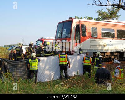 (220906) -- KUNFEHERTO, 6. September 2022 (Xinhua) -- Polizei und Feuerwehrleute arbeiten am 5. September 2022 am Unfallort in der Nähe von Kunfeherto, Ungarn. Sieben Menschen sind gestorben, nachdem Anfang Montag ein Auto mit einem Zug in Südungarn kollidierte, teilte die Polizei mit. (Ferenc Donka/MTI über Xinhua) Stockfoto