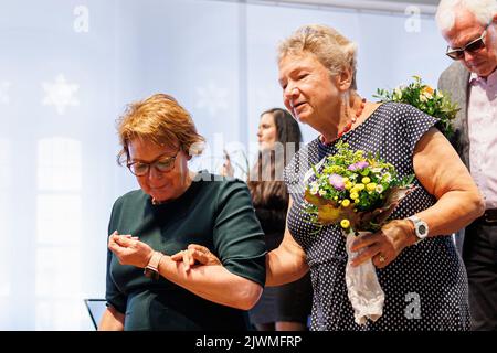 06. September 2022, Niedersachsen, Hannover: Die niedersächsische Gesundheitsministerin Daniela Behrens (SPD, l) hilft Dagmar Krause von der Bühne, nachdem sie während der Veranstaltung „Leiden und Ungerechtigkeit erkennen“ im Alten Rathaus über ihre Erfahrungen als Opfer sprach. Die „Recognition and Help“-Stiftung wurde von der Bundesregierung gegründet, Die Staaten und die protestantischen und katholischen Kirchen erkennen das Leid der Betroffenen an, die in der Fede als Kinder und Jugendliche zwischen 1949 und 1975 Jahren in stationäre Einrichtungen für Behinderte oder psychiatrische Betreuung gebracht wurden Stockfoto