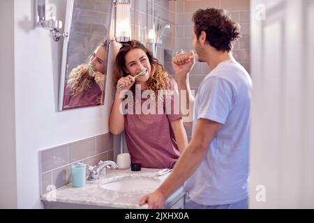 Paar Tragen Schlafanzug In En Suite Badezimmer Zähneputzen Zusammen Stockfoto