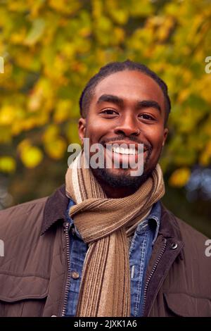 Kopf Und Schultern Porträt Des Menschen Auf Einem Spaziergang Durch Die Herbstliche Landschaft Gegen Goldene Blätter Stockfoto