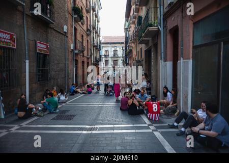 Pamplona, Spanien - Juli 30: Gruppe von glücklichen jungen Menschen, die auf dem Boden sitzen und Bier trinken. Die Freunde genießen eine schöne Zeit zusammen, Spaß am h Stockfoto