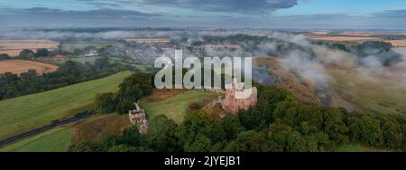 Norham Castle steigt durch den frühen Morgennebel auf Stockfoto