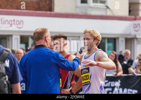 Jonnie Pfacock und die anderen Sprinter am Ende ihres Rennens bei den Great North City Games, die in der High Street, Stockton on Tees, Großbritannien, ausgetragen wurden Stockfoto