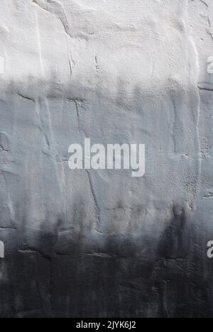 Close up of a textured wall painted in grey tones as background Stockfoto