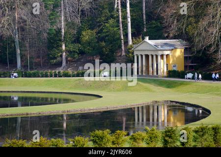 Der Tempel der Frömmigkeit spiegelt sich in den Gewässern von Moon & Crescent Ponds in Fountains Abbey und Studley Royal Water Garden, North Yorkshire, England, Großbritannien, wider. Stockfoto