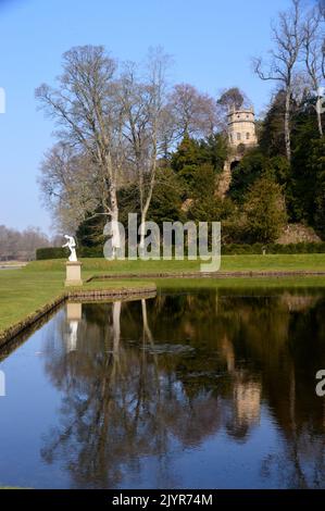 Die Statue von Galen und der Octagon Tower (Folly) von Crescent Pond in Fountains Abbey und Studley Royal Water Garden, North Yorkshire, England, Großbritannien. Stockfoto