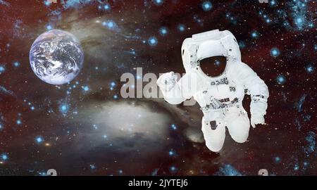 Astronaut in einem Raumanzügen im Weltraum. Spaceman auf dem Hintergrund des Planeten. Kosmische Landschaft. Gemischte Medien Stockfoto