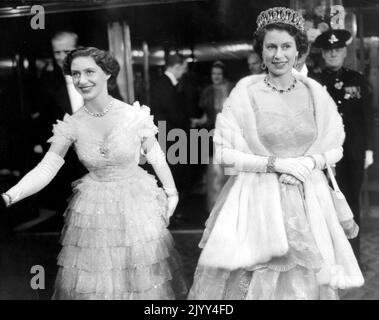 26. Oktober 1953 - London, England, Großbritannien - KÖNIGIN ELIZABETH II., rechts, mit ihrer Schwester PRINZESSIN MARGARET, links, und PRINZ PHILIP, teilweise verschwommener Blick hinter die Prinzessin, kommen am Odeon Theatre, Leicester Square an, um an der königlichen Filmvorstellung von 'Rob Roy' in Abendkleidung teilzunehmen. (Bild: © Keystone Press Agency/ZUMA Press Wire) Stockfoto