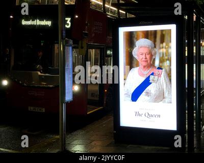 London, Großbritannien. 08. September 2022. Ein Neonschild an einer Bushaltestelle auf der Chiswick High Road zeigt ein Foto von Queen Elizabeth II mit den Daten 1926-2022. Die britische Königin Elizabeth II. Ist tot. Sie starb am Donnerstag im Alter von 96 Jahren auf ihrem Landsitz Balmoral Castle in Schottland. Quelle: Gaby Mahlberg/dpa/Alamy Live News Stockfoto