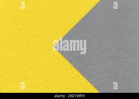 Struktur aus gelbem Papier Hintergrund, halb zwei Farben mit grauem Pfeil, Makro. Struktur aus dichtem Bastelkarton. Fühlte mich abstrakt Hintergrund Nahaufnahme. Stockfoto