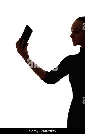 Frau Silhouette mobile Video Anruf Telefon Selfie Stockfoto