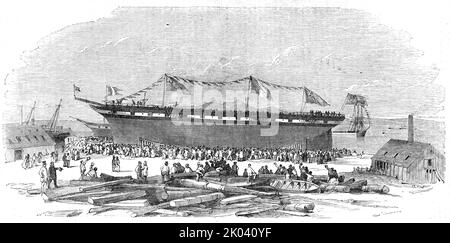 Start von "der Napoleon III", in Ardrossan, 1854. Szene auf der Schiffswerft von Barr und Shearer auf dem River Clyde in Schottland. '...die Namenszeremonie... wurde von der Lady Egidia Montgomery anmutig durchgeführt... während das Schiff große Segelkräfte besitzt, hat es auch große Tragfähigkeiten und wurde unter der Aufsicht ihres erfahrenen Kommandanten Captain Crawford ausgestattet. Bei jeder neuen Verbesserung...der Figurenkopf ist eine ausgezeichnete Darstellung des Kaiser Napoleon III, wunderschön gestaltet und ausgeführt von Herrn Robertson von Liverpool; die Besitzer sind die Herren Peter und Thom Stockfoto