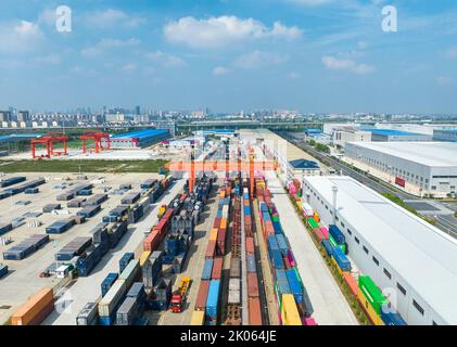 NANTONG, CHINA - 10. SEPTEMBER 2022 - am Haian Railway Logistics-Stützpunkt in Nantong, Jiang, betreiben Arbeiter schwere Hebezeuge zum Anheben von Containern Stockfoto