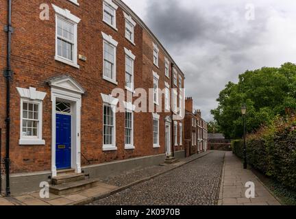 Chester, Vereinigtes Königreich - 26. August 2022: Rote Backsteingebäude mit bunten Türen in typisch englischer Art und Weise im historischen Stadtzentrum von Chester Stockfoto