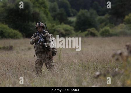 US-Soldat der Alpha Company, 2. Bataillon 503 Infanterie-Regiment (Co. 2-503 IN) führt während der Übung Sabre Junction 22 auf dem Hohenfels Training Area, Joint Multinal Readiness Center (JMRC) in Hohenfels, Deutschland, einen Luftangriff durch, der von einer Landezone aus durchgeführt wird, 9. September 2022. Sabre Junction 22 ist eine Kampftrainingsrotation, mit der die Bereitschaft des 173. IBCT (ABN) bei der Durchführung von Operationen in einer gemeinsamen, kombinierten Umgebung bewertet und die Interoperabilität mit den teilnehmenden Alliierten und Partnerländern gefördert werden soll. (USA Armeefoto von CPL. Eric Perez) Stockfoto