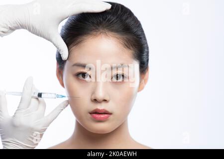 Junge Chinesin, die Botox-Behandlung erhält Stockfoto