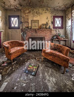 Verlassene Haus mit Bett und Stühlen und Verfall Stockfoto