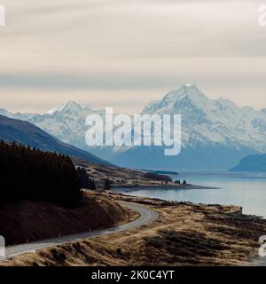 Blick auf den majestätischen Aoraki Mount Cook mit der Straße zum Mount Cook Village. Im Winter in Neuseeland übernommen. Stockfoto