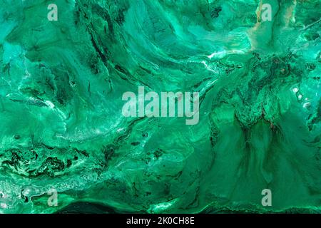 Abstrakter Hintergrund aus gemischten Schattierungen von grünem Nagellack mit einem pastellfarbenen Marmormuster. Flüssige bunte Hintergrund malen kreative Pastell kalt grünen Farbton Stockfoto