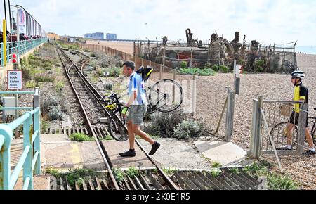 Brighton UK 11.. September 2022 - Ein Radfahrer überquert die Volks-Bahnlinie am Brighton-Strand, nachdem er an der Fahrradtour von London nach Brighton teilgenommen hat. Die Fahrt wird vielen Wohltätigkeitsorganisationen wie dem Great Ormond Street Hospital childrenÕs Charity : Credit Simon Dack / Alamy Live News Stockfoto