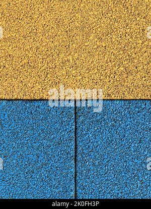 Gummiboden Hintergrund, Textur, Hintergrund. Oberfläche im ukrainischen Stil. Neue körnige Gummibeschichtung und zweifarbige Oberfläche. Teppich-Loot Stockfoto