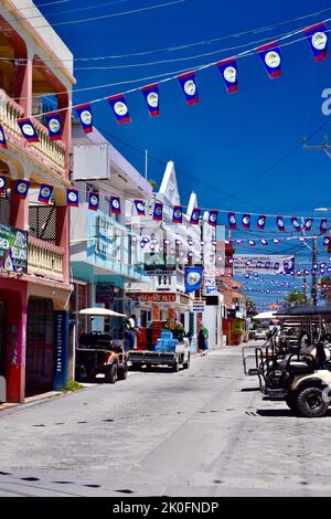 Die Straßen von San Pedro Town, Ambergris Caye, Belize wurden für den St. George's Caye Day und den Belize Independence Day dekoriert, mit der Flagge von Belize. Stockfoto