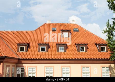 Gefliestes, rotes Dach auf alten Häusern, Nahaufnahme. Hintergrund der Altstadt und roten Dächern Stockfoto