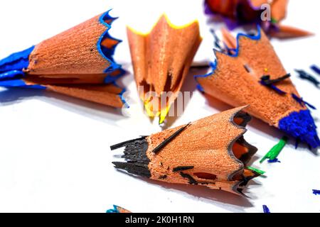 Holzschnitzeln von Buntstiften auf weißem Hintergrund. Feine Scherben und Bleistiftfragmente Stockfoto