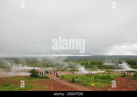 Eine Luftaufnahme einer Gruppe von Menschen rund um den Strokkur-Geysir in Island Stockfoto