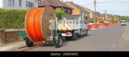 Glasfaser superschnelle Breitband-Infrastruktur große Kabeltrommel & LKW Abschleppwagen Wohn Straße Bürgersteig Graben Werke Crossover geschlossen Essex UK Stockfoto