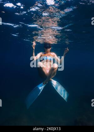 07. August 2021. Varna, Bulgarien. Frau mit Flossen Spaß unter Wasser im Meer mit Sonnenlicht. Junges Mädchen tauchen unter Wasser. Stockfoto