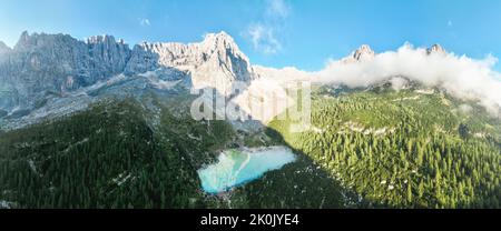 Blick von oben, herrlicher Panoramablick auf den See Sorapis (Lago di Sorapis) mit seinem türkisfarbenen Wasser, umgeben von Wald und Bergen. Stockfoto