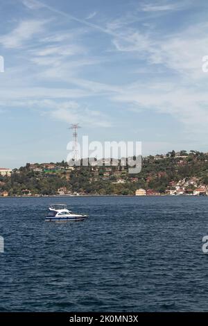 Blick auf eine Yacht, die auf dem Bosporus und der asiatischen Seite Istanbuls vorbeifährt. Es ist ein sonniger Sommertag.schöne Reiseszene. Stockfoto