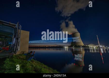 Essenbach, Deutschland. 12. September 2022. Greenpeace-Aktivisten projizieren riskant & unnötig auf den Kühlturm des Atomkraftwerks Isar 2. Quelle: Armin Weigel/dpa/Alamy Live News Stockfoto