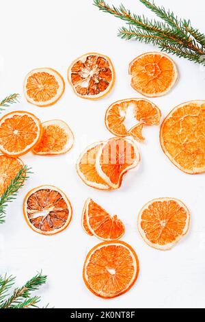 Weihnachten Hintergrund. Getrocknete Orangen und Fichtenzweige. Minimalistischer Neujahr Hintergrund 2023 Stockfoto