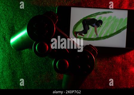 Gamer-Arbeitsraum-Konzept. Gaming-Setup. Draufsicht auf eine Gaming-Ausrüstung, Joystick und ein Smartphone Stockfoto