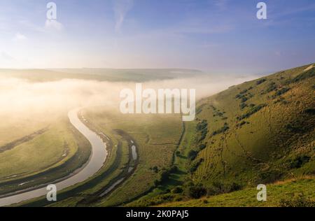 Misty Morgen Blick von High und über der Cuckmere Fluss und Tal, die hinunter zur Küste und Cuckmere Haven auf der Südseite nach Sussex sou Stockfoto